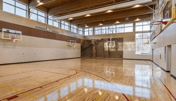 The gymnasium at Hazelden’s Plymouth campus supports many activities for patients to unwind or become involved in more structured group activities. The basketball areas can be divided for multiple games and a climbing wall used for trust-building activities is provided at the far end. The gym can also be used for large public and non-public functions. Photo: Paul Crosby Photography.