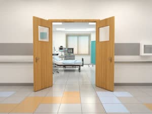 featured image showing Hospital doors opening to a hospital room